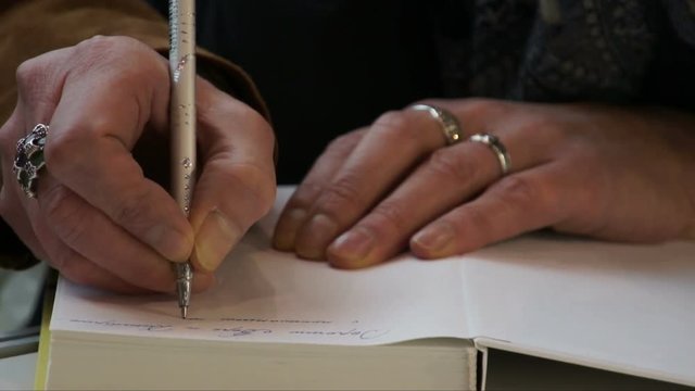 Female hands with a pen.