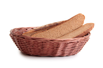 Obraz premium Pieces of bread in a wicker basket on white background