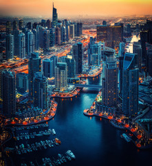 Fototapeta premium Scenic aerial skyline: fantastic view over skyscapers of Dubai, UAE, at night. Artistic travel and architecture background. 