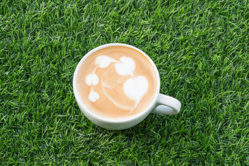 Coffee in white cup on the Artificial grass