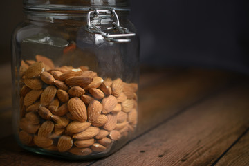 Raw almonds in Glass Jar.