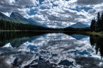 Fototapeta na wymiar Clear water, mountains and reflections. Honeymoon lake. Banff National Park. Alberta. Canada. 
