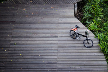 Black folding bike on the wood bridge