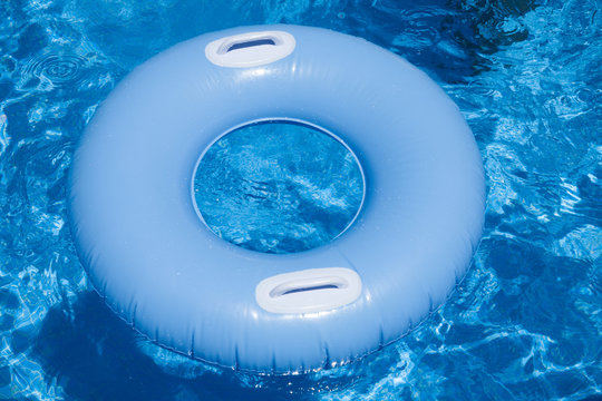blue floater with handles in water of pool