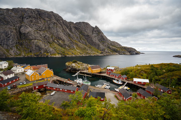 The Port of Nusfjord village with its yellow and red fishing hut