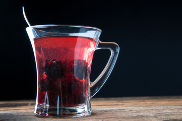 Warming drink with raspberry and blackberry. Copyspace