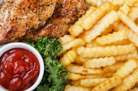 Grilled chicken steak, french fries and salad