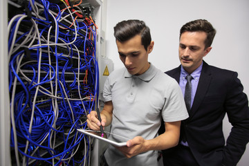 Men in network server room