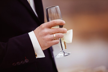 Closeup image of male hand with sparkling champagne glass 