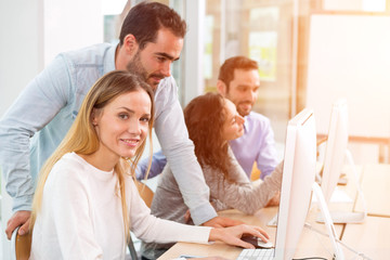 Young attractive people taking a training course with formator