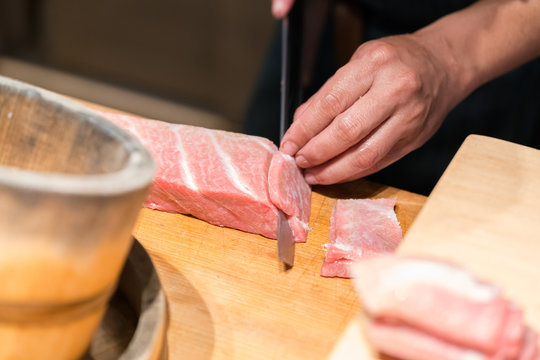 Sushi Chef Cutting Tuna Otoro  (Fatty tuna) Sashimi
