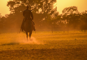 Warrior in sunset,Riding warrior silhouette in sunset