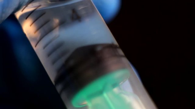 Macro photography of a syringe with the liquid