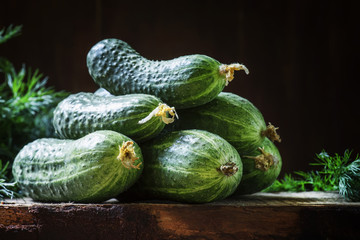 Fresh organic cucumbers. Vintage wooden background. Low key, sel