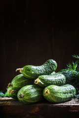 Fresh organic cucumbers. Vintage wooden background. Low key, sel