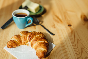 Breakfast with coffee and croissant
