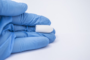 Suppository with medicine (laxative or to treat proctological diseases) lies in the hand of the...