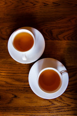 Cups of tea on a wooden background top view