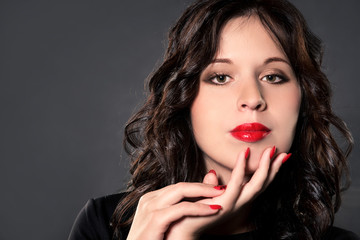 beautiful brunette with bright lipstick and nails
