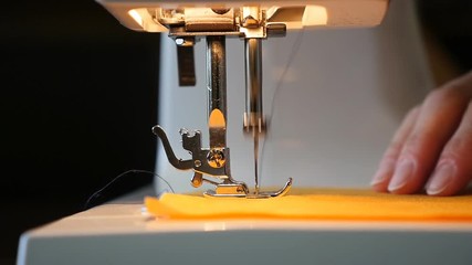 Woman sewing on the sewing machine - slow motion