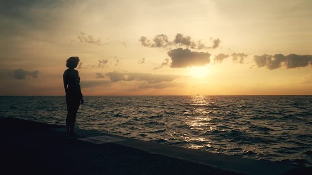 Runner athlete stands at seaside