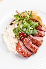 Roast goose breast on white plate, fine dining