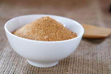 Ginger powder with sugar on sackcloth floor.