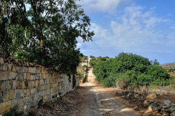 The roman road runs across the island of Malta from Xemxija, St Pauls on the east coast bay to Golden bay on the west coast.