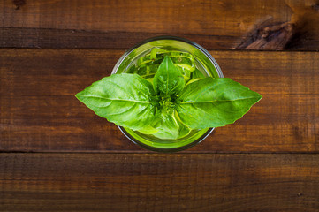 Refreshing cocktail of cucumber and mint leaves on a wooden background, top view