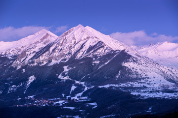 Fototapeta na wymiar Twilight on the Petite and Grande Autane mountain peaks with view on Saint Leger Les Melezes. Champsaur, Hautes Alpes, Southern French Alps, France