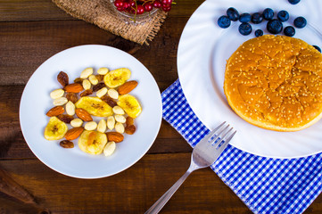 Healthy eating, diet concept - nuts and berries in a bowl on a wooden table.