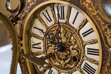 Detail of an old clock with old key winder. Concept of the time.