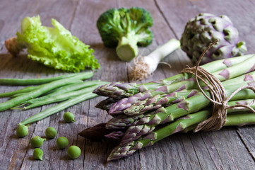 Assorted green vegetable on wooden table