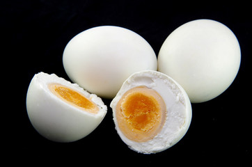 salted egg on black background