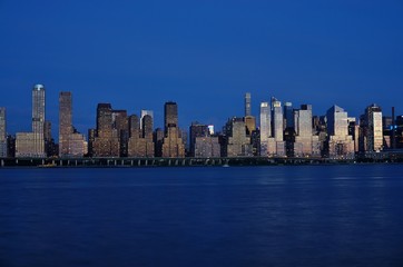 Fototapeta na wymiar The Manhattan, New York skyline seen at night from Edgewater, New Jersey