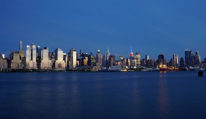 Fototapeta na wymiar The Manhattan, New York skyline seen at night from Edgewater, New Jersey