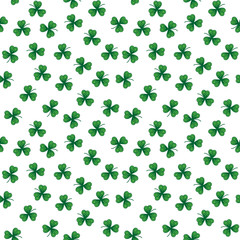Cute funny seamless background pattern with stylized green clover leaves isolated on the white fond. Vector illustration eps 10