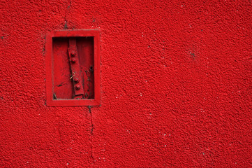 Red paint rough wall . Abstract background texture