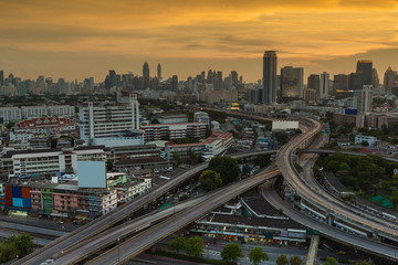 Aerial view city and highway intersection over sunset background