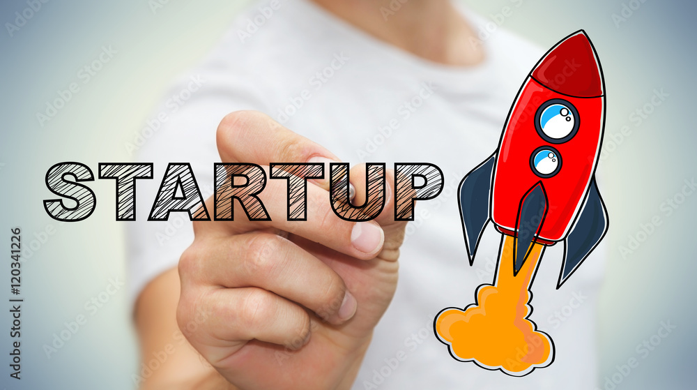 Poster businessman drawing startup text and red rocket with a pen