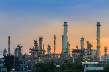 Fototapeta na wymiar Sunrise background over petrol chemical refinery on cloudy day