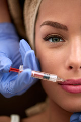 Woman receiving injection in lips