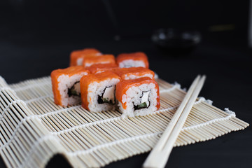 Japanese sushi on a black background (foreground)