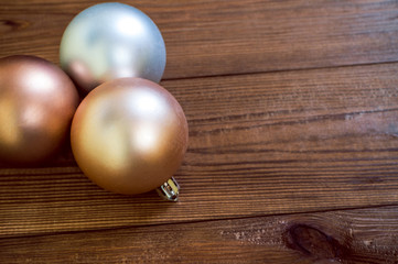 Golden christmas balls on the wooden table