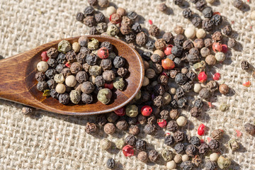 Pepper on wooden spoon, aerial view