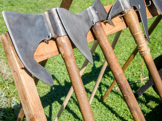medieval battle axes aligned in rack