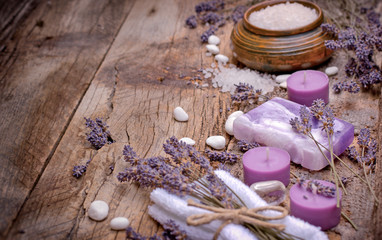 Fototapeta na wymiar Spa treatment for your health and pleasure - lavender soap, scented salt and spa stones