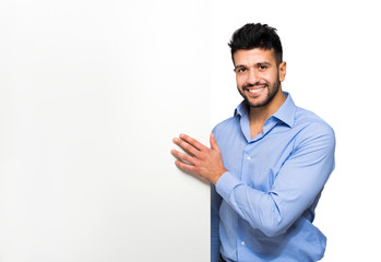 Handsome man showing a blank board