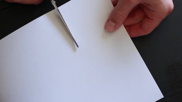 Cutting paper with scissors