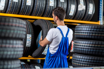 Mechanic sale a new tire for car